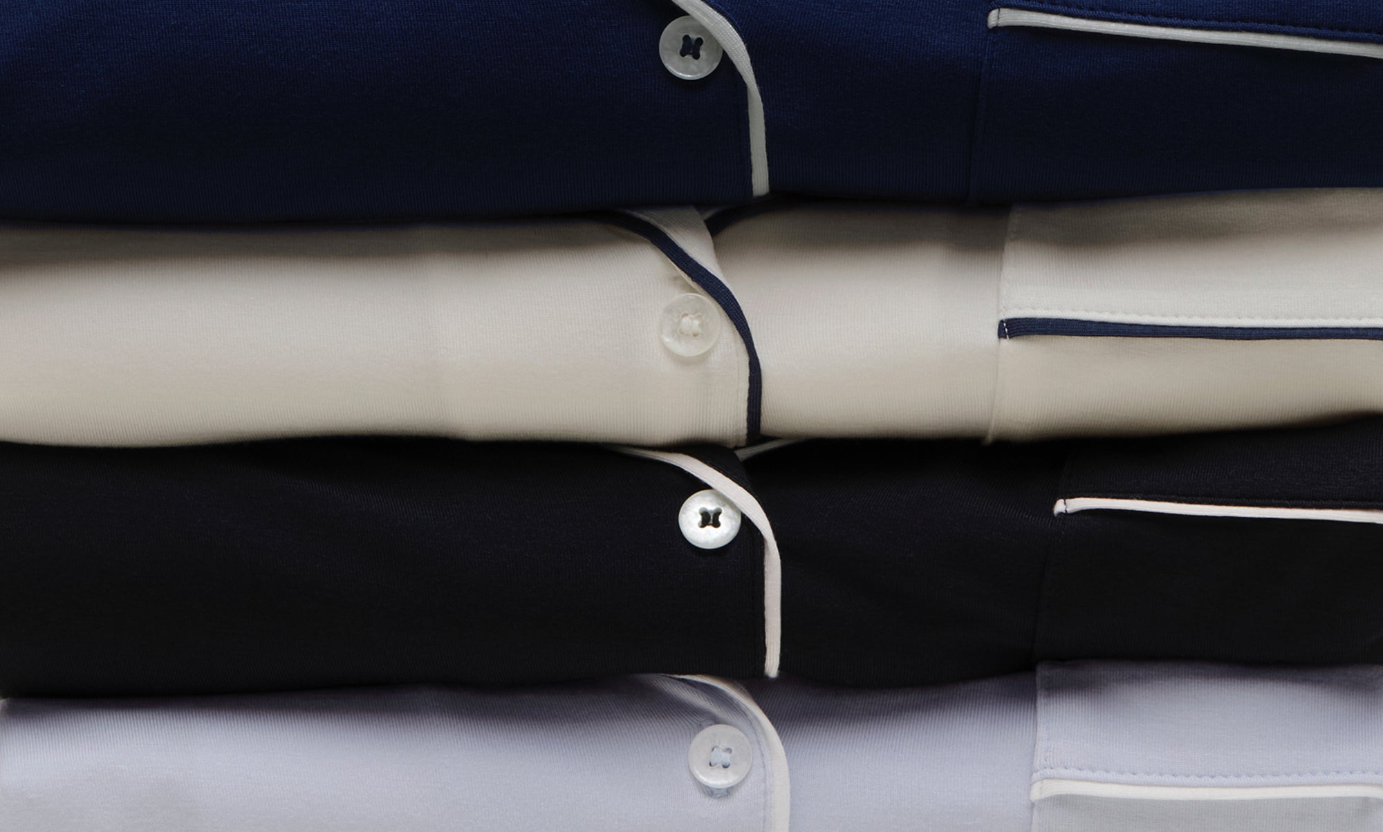 stack of Gisele PJs in Navy, Pure Ivory, Black and Ice Blue