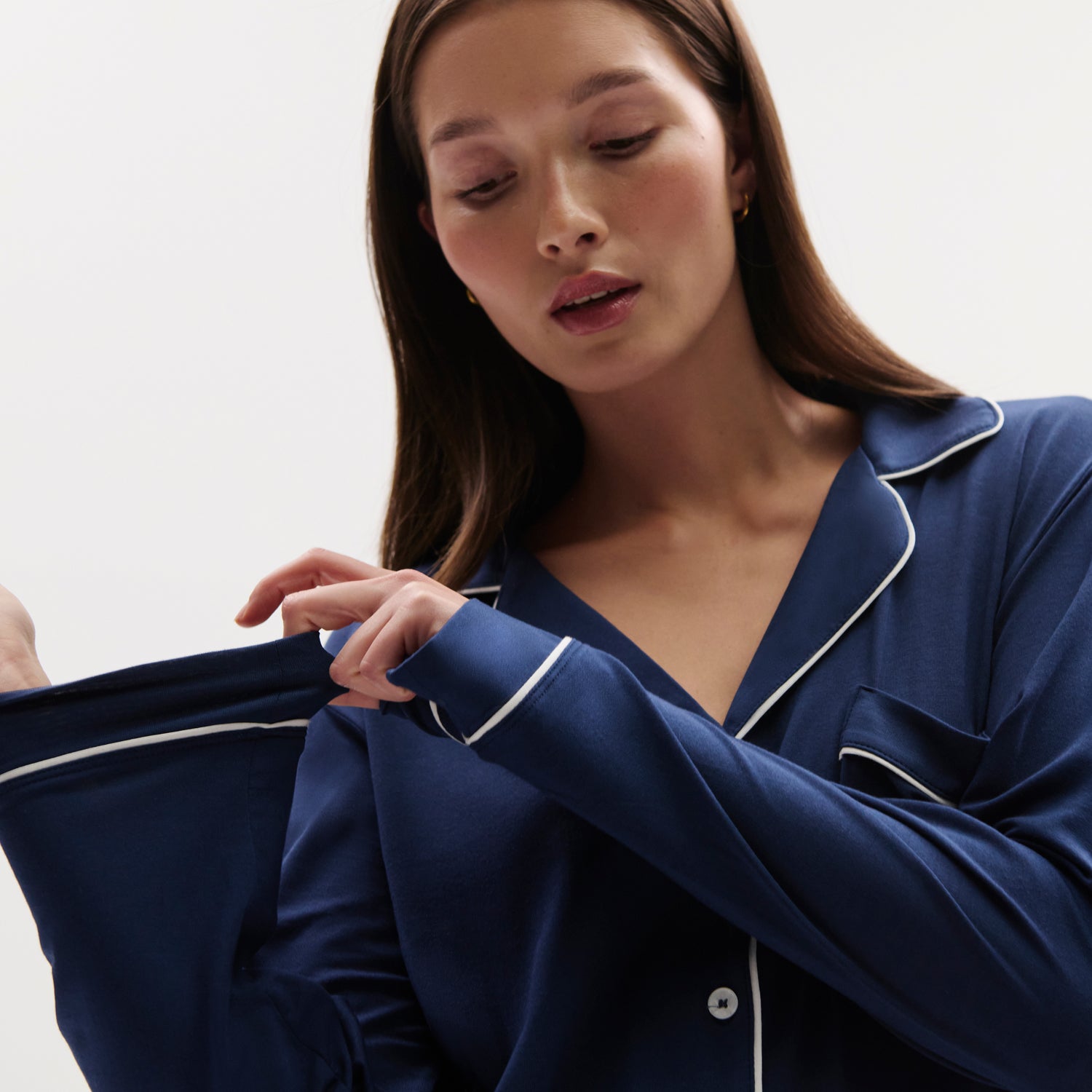 Model is wearing Gisele TENCEL™ Modal Long PJ Set in Navy/Ivory