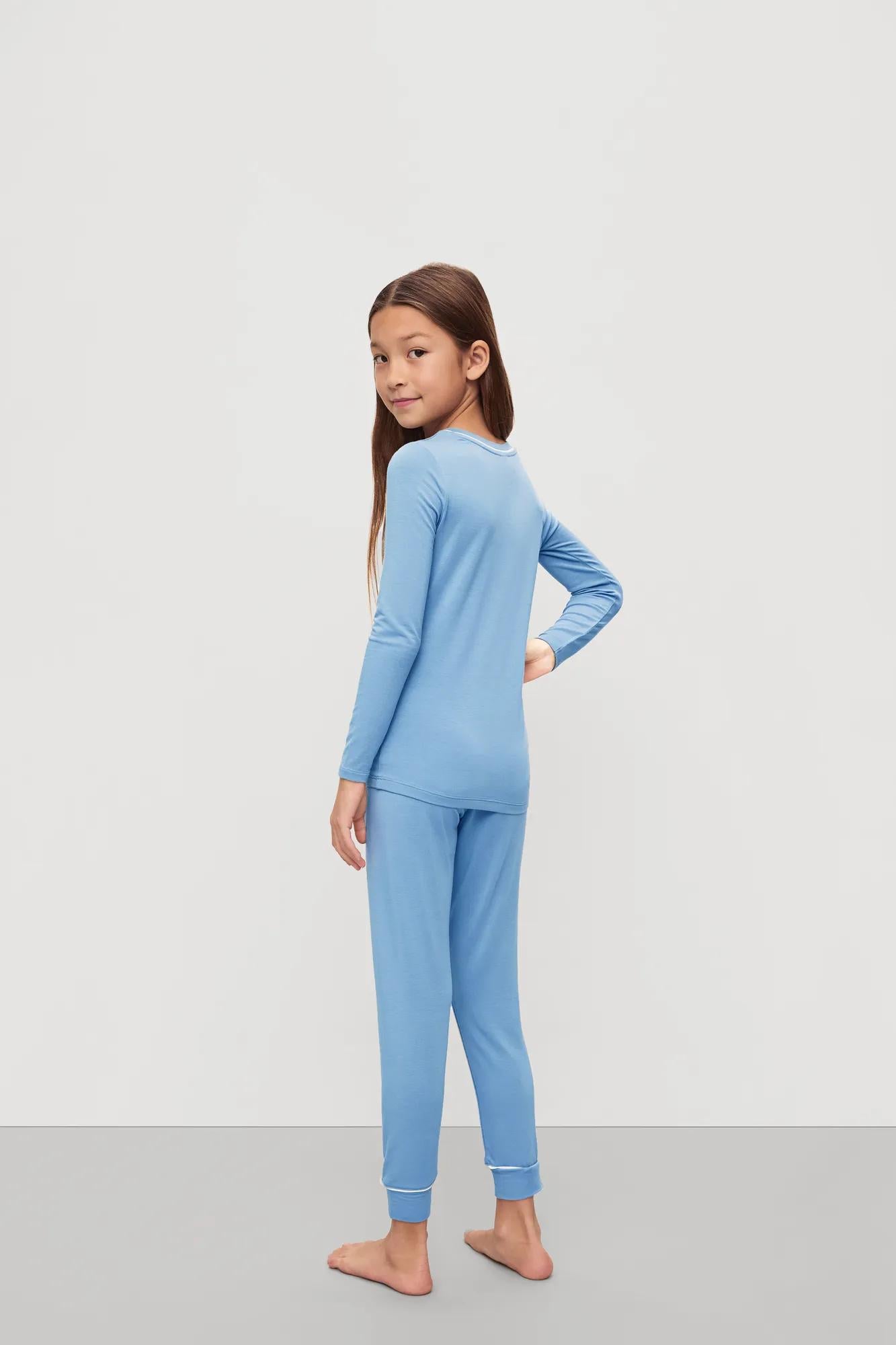 Model is wearing Kids TENCEL™ Modal Unisex Long PJ Set in Summer Blue/White