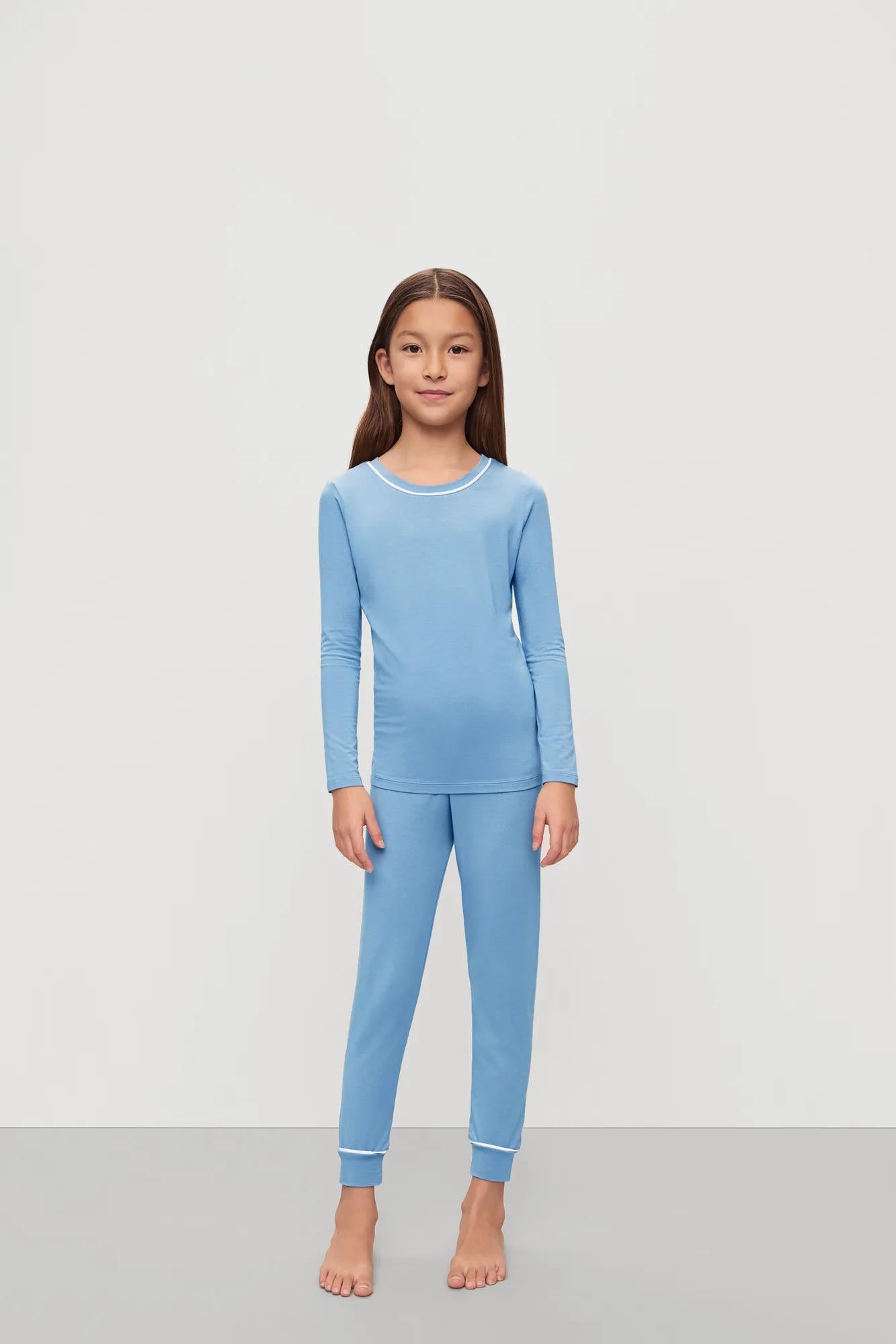 Model is wearing Kids TENCEL™ Modal Unisex Long PJ Set in Summer Blue/White