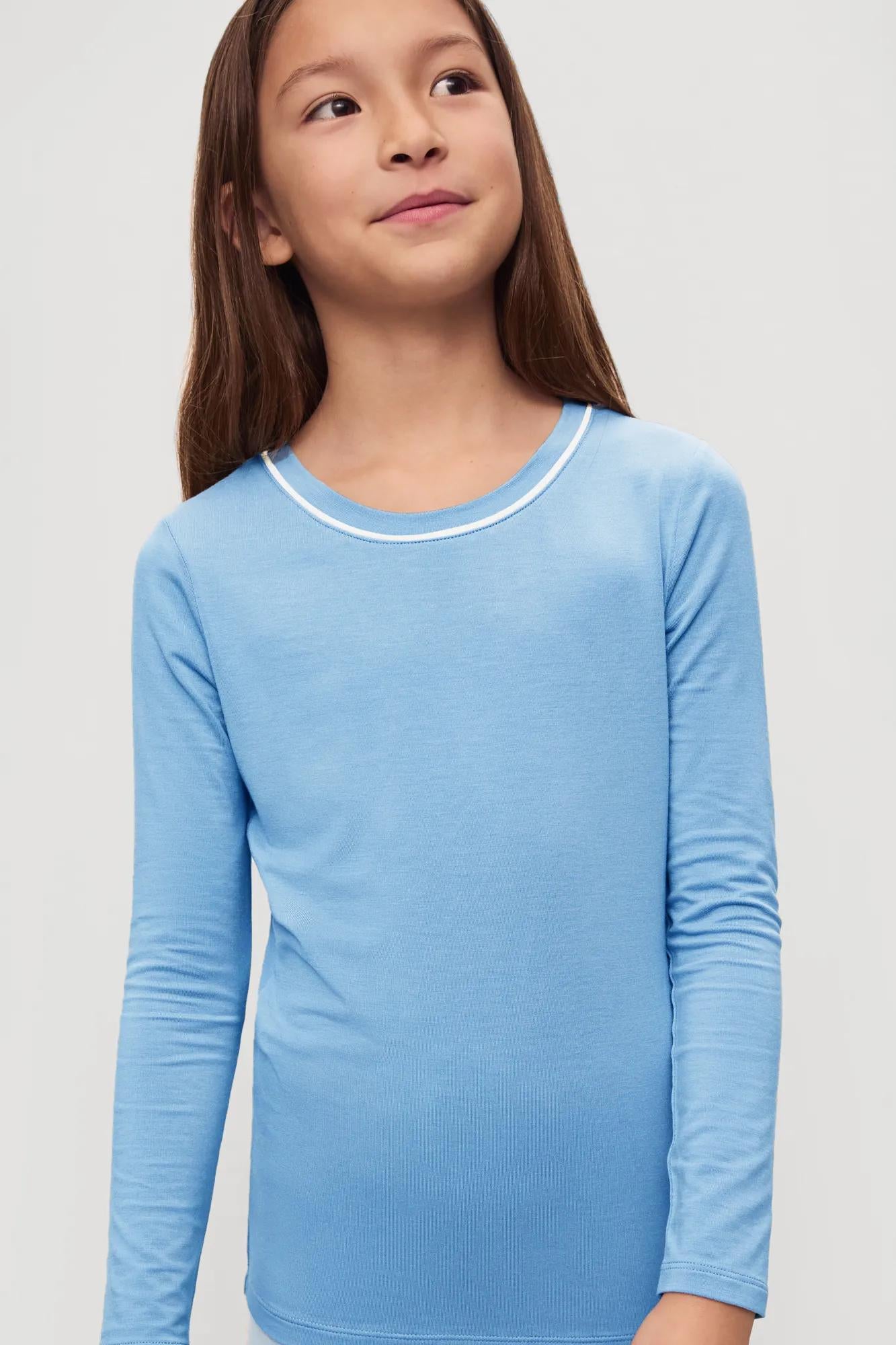 Model is wearing Kids TENCEL™ Modal Unisex Long PJ Set in Summer Blue/White