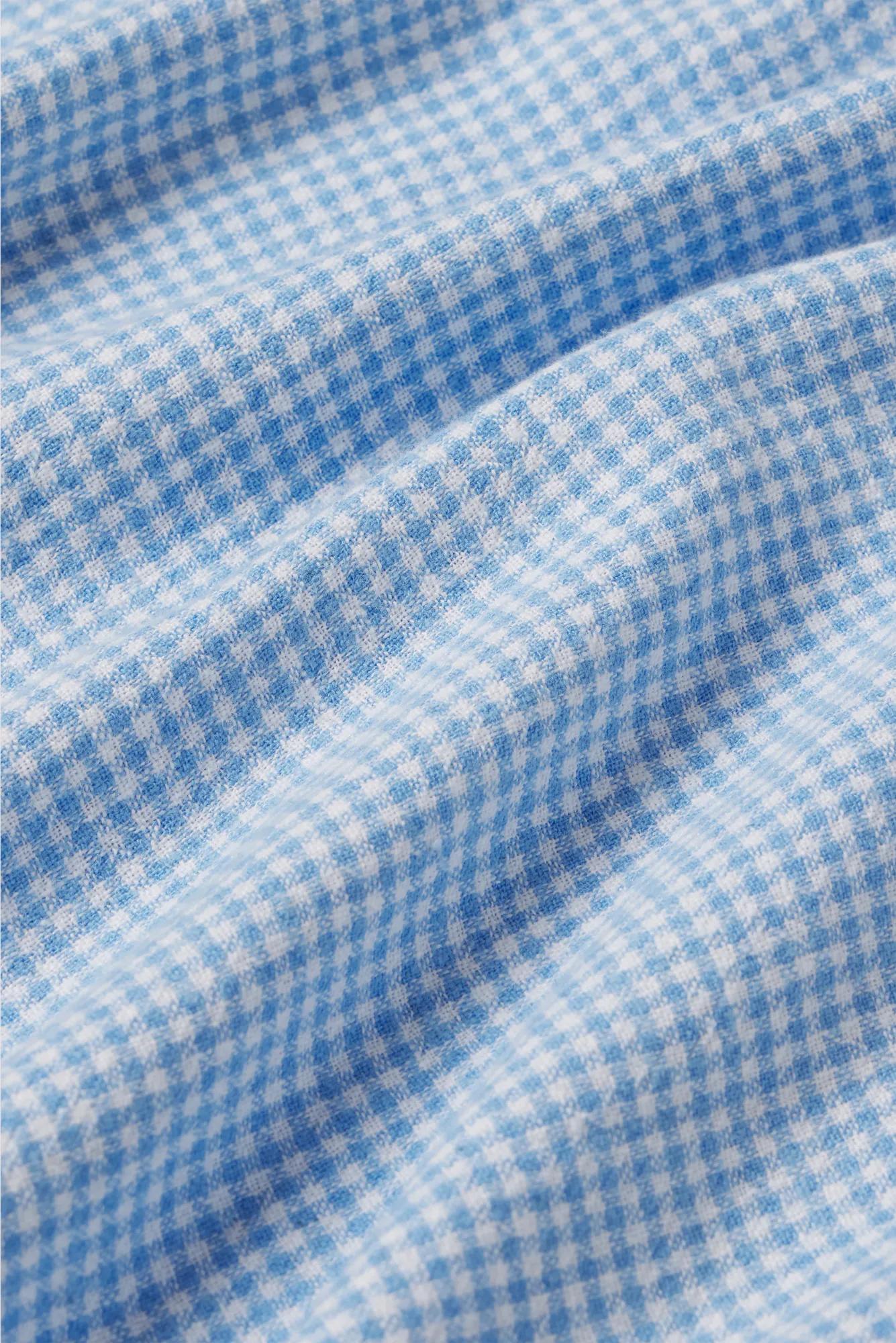 Model is wearing Linen Blend Relaxed Quarter Sleeve Top in Gingham White/Summer Blue