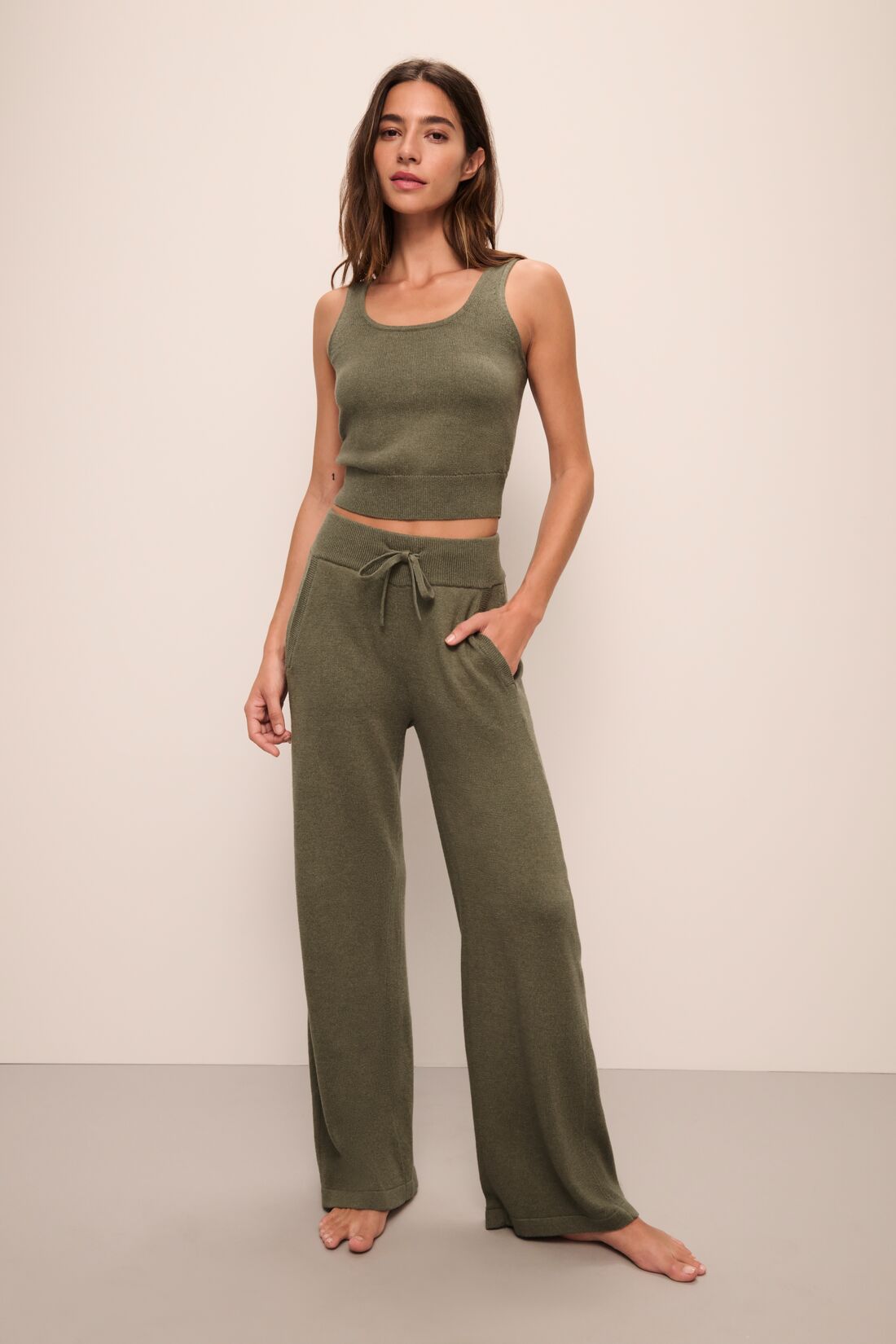 Model wears the Recycled Sweater Cropped Tank in Moss.
