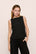 Model is wearing Organic Linen Knit Boat Neck Crop Tank in Black