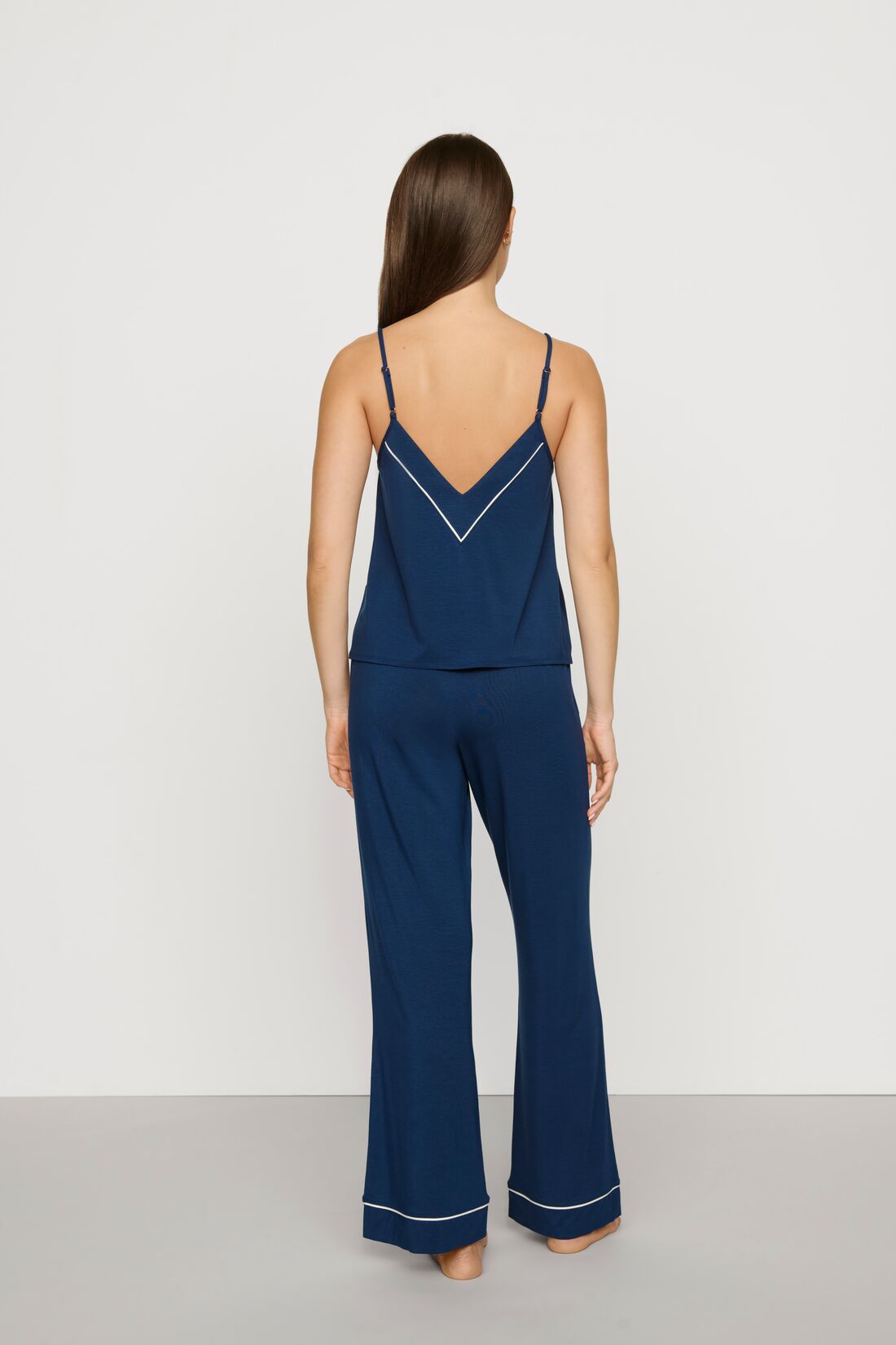 Model is wearing Gisele TENCEL™ Modal V Neck Cami & Pant PJ Set in Navy/Ivory