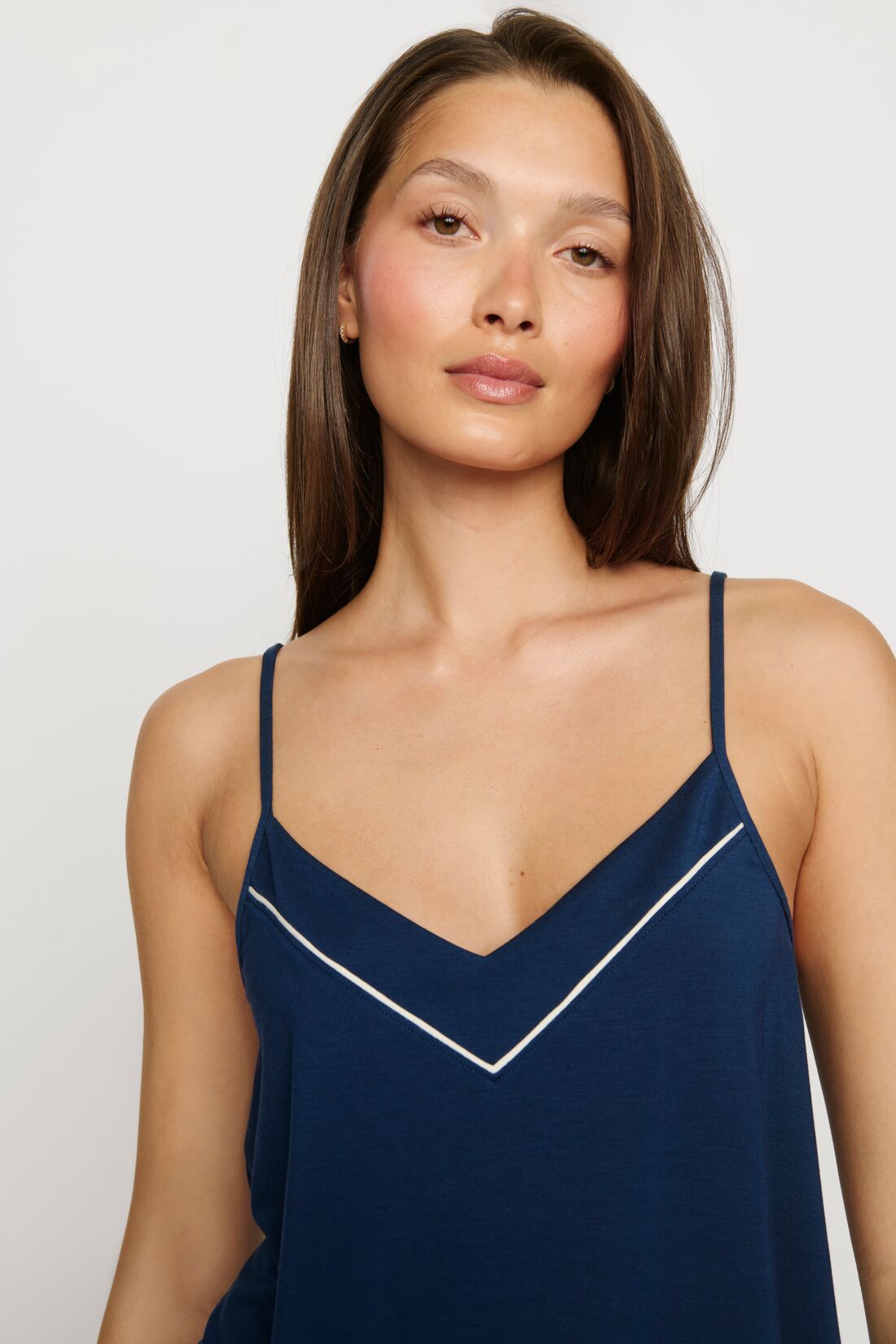Model is wearing Gisele TENCEL™ Modal V Neck Cami & Pant PJ Set in Navy/Ivory