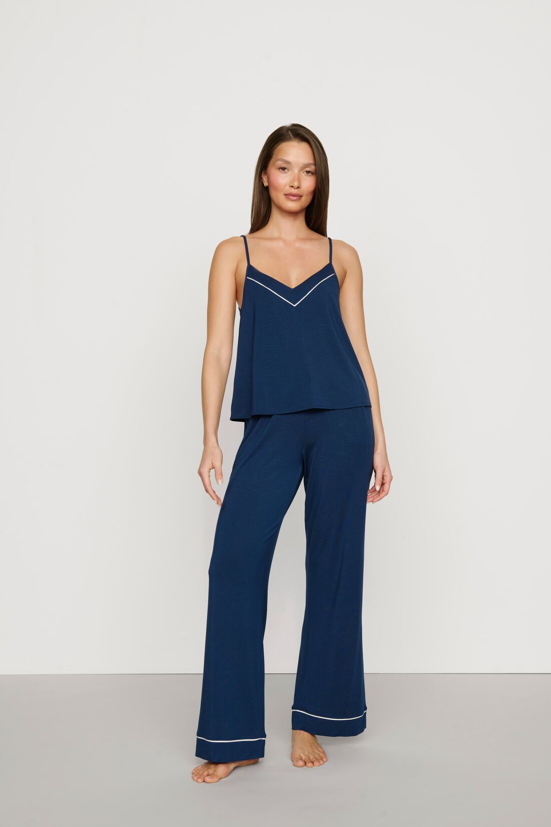 Model is wearing Gisele TENCEL™ Modal V Neck Cami & Pant PJ Set in Navy/Ivory