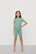 Model is wearing Kids TENCEL™ Modal Unisex Short PJ Set in Seagrass/White