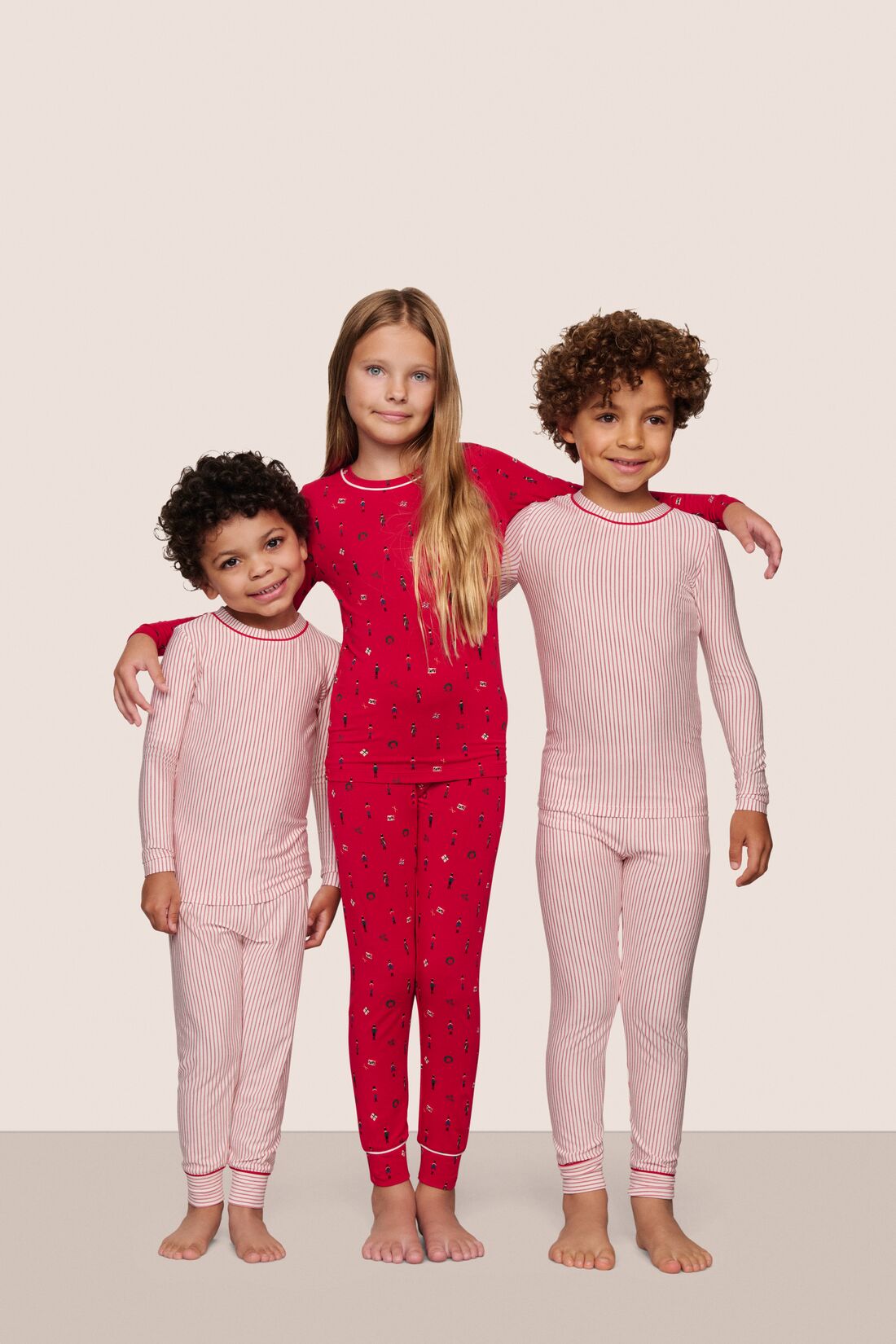 Kids wearing PJs in Duo Stripe Holly Red/Holly Red and Nutcracker Red/Ivory