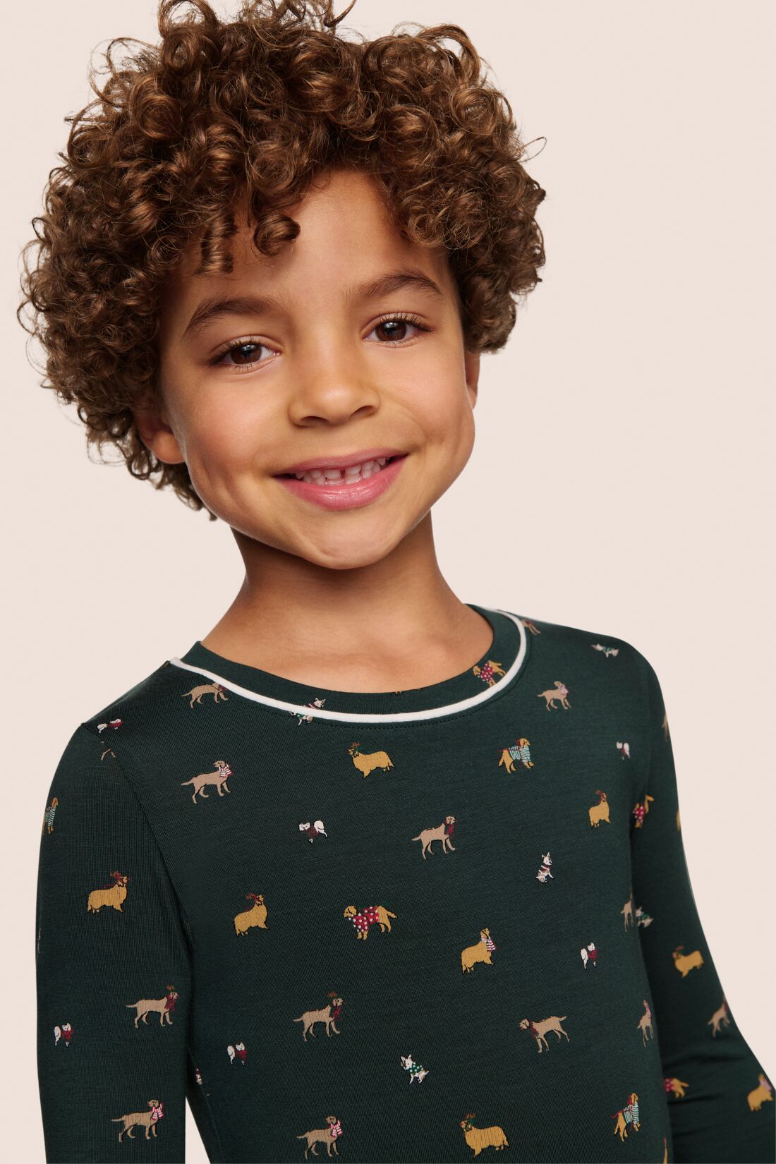 Model is wearing Kids Printed TENCEL™ Modal Unisex Long PJ Set  in Holiday Dogs Pine/Ivory