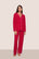 Model is wearing Gisele TENCEL™ Modal Long PJ Set  in Holly Red/Ivory