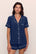 Model is wearing Gisele TENCEL™ Modal Relaxed Short PJ Set in Navy/Ivory