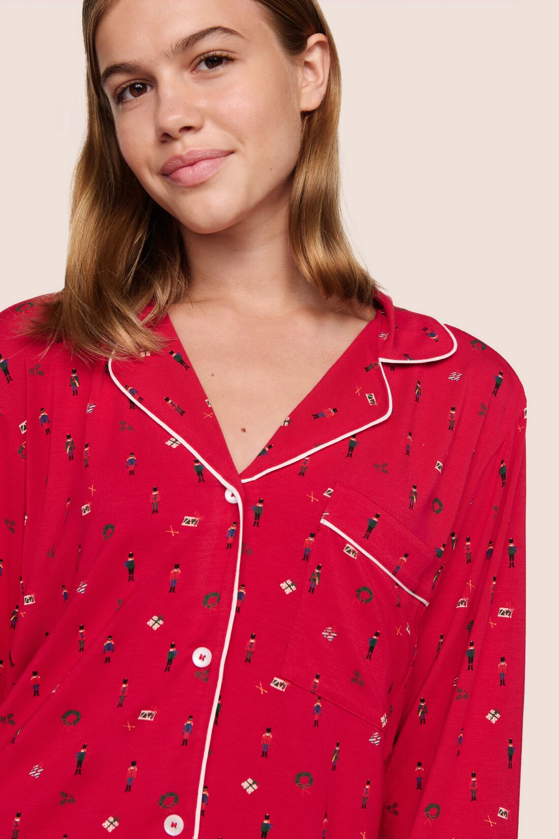 Model is wearing Gisele Printed TENCEL™ Modal Long PJ Set in Nutcracker Holly Red/Ivory