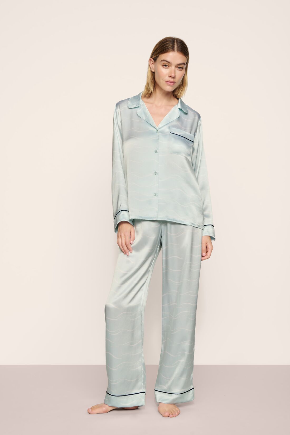 Model is wearing Inez Washable Silk Printed Long PJ Set in Waves Memorable Blue/Navy