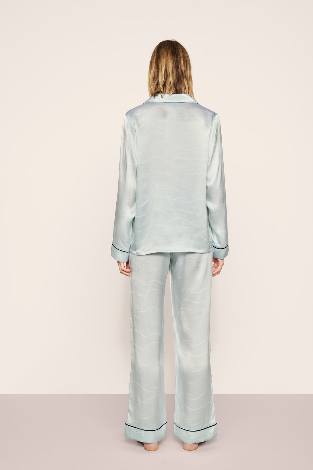 Model is wearing Inez Washable Silk Printed Long PJ Set in Waves Memorable Blue/Navy