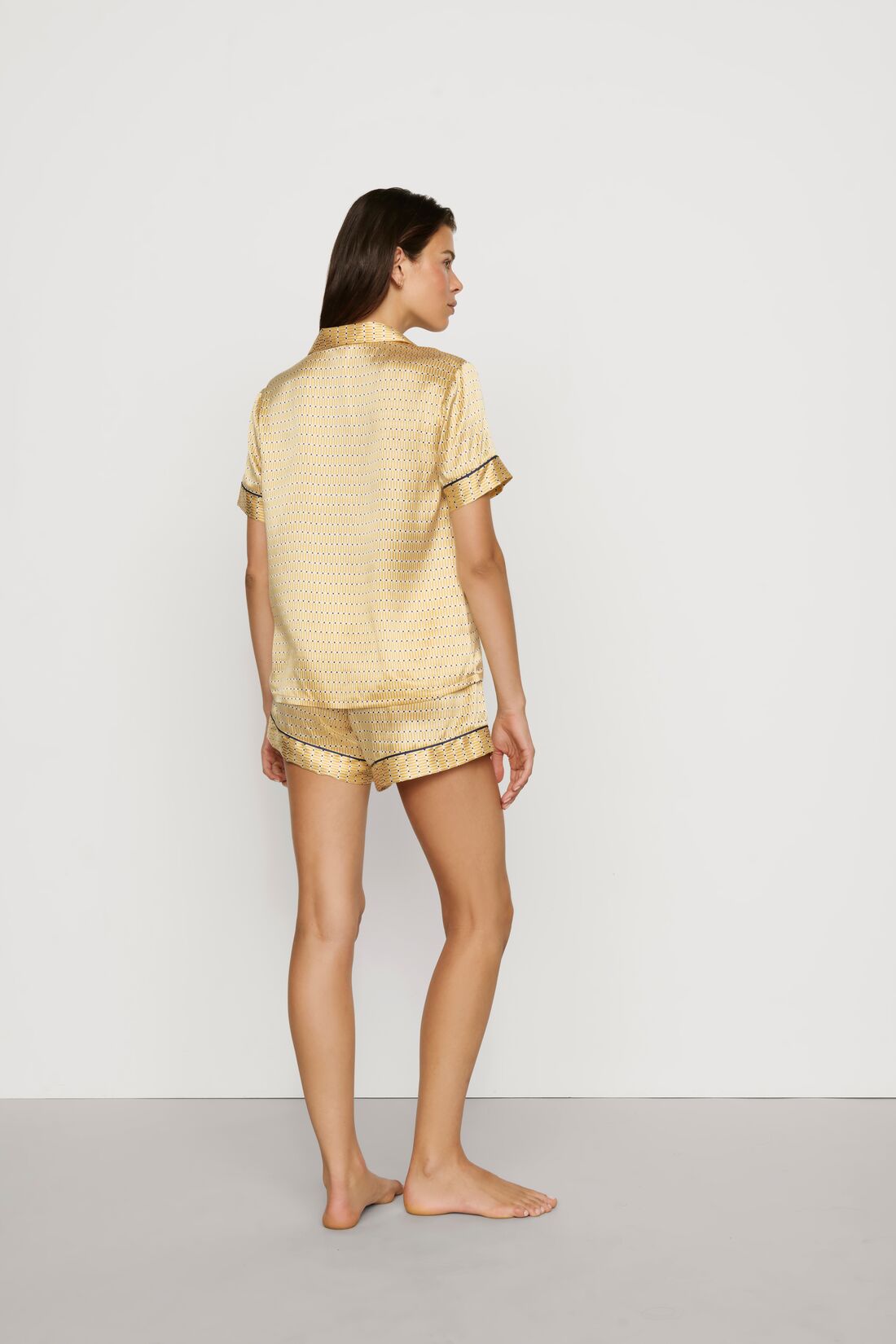 Model is wearing Inez Washable Silk Printed Short PJ Set in Stained Glass Sunbeam/Navy