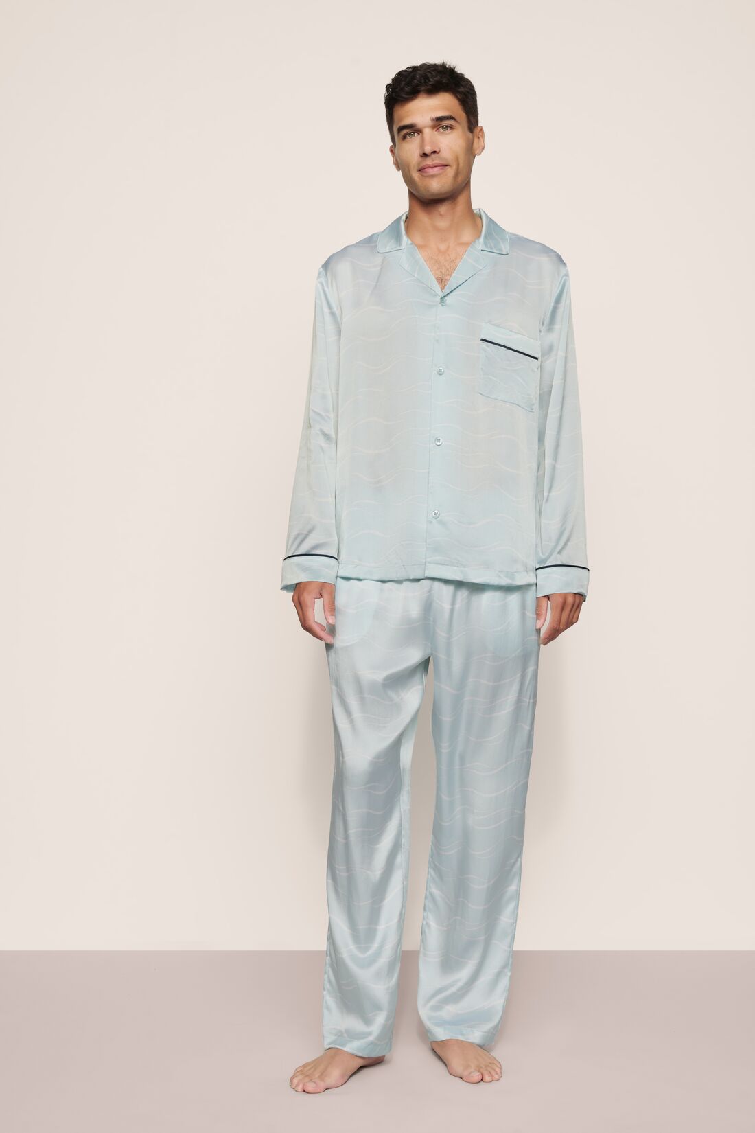 Model is wearing Charles Washable Silk Printed Long PJ Set in Waves Memorable Blue/Navy