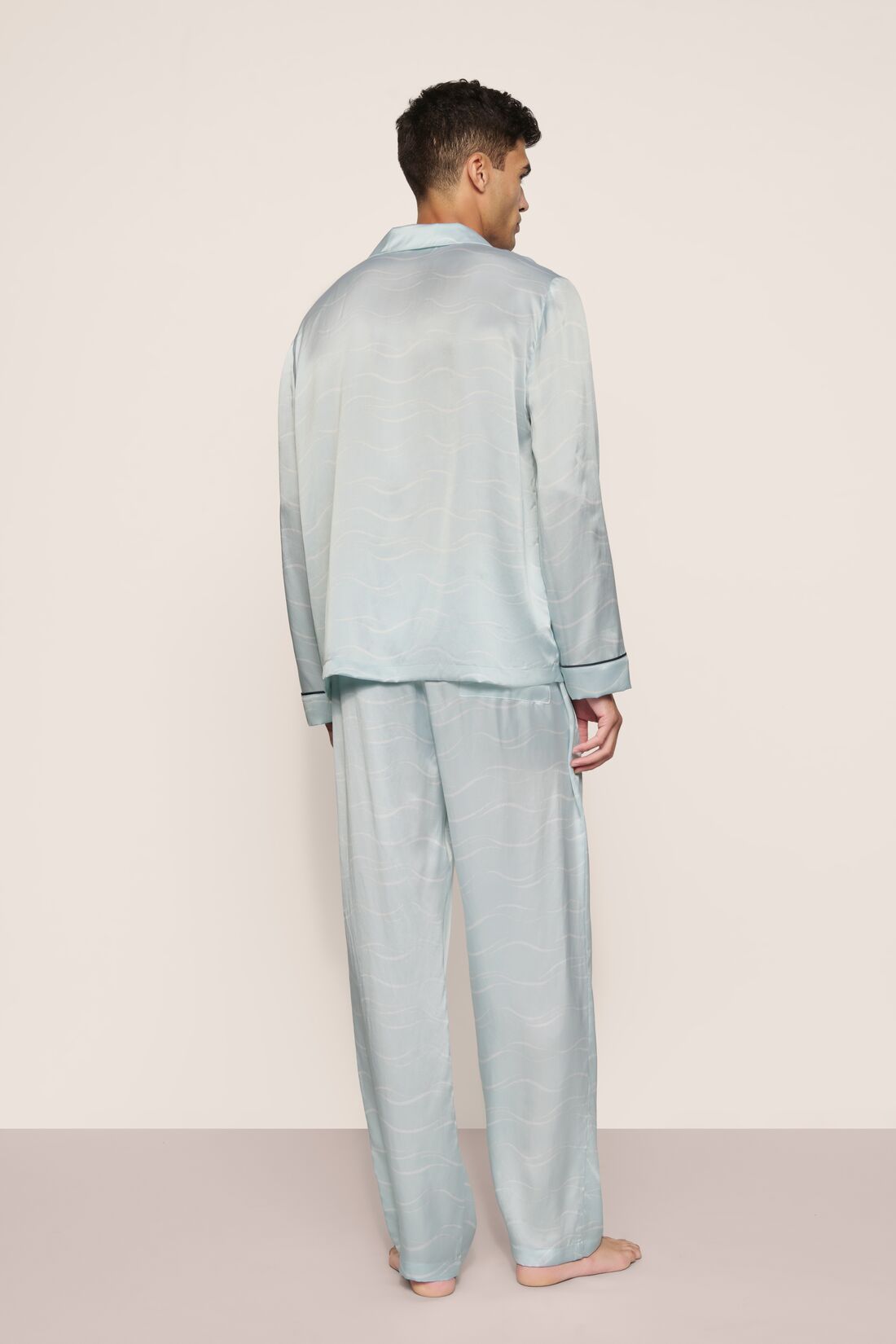 Model is wearing Charles Washable Silk Printed Long PJ Set in Waves Memorable Blue/Navy