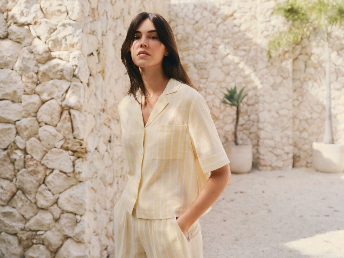 Model is wearing Nautico Relaxed Short Sleeve & Pant PJ Set in Classic Stripe Sunbeam/Ivory