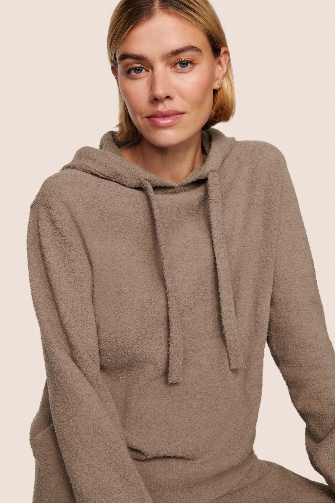 Model is wearing Recycled Boucle Hoodie  in Deep Taupe