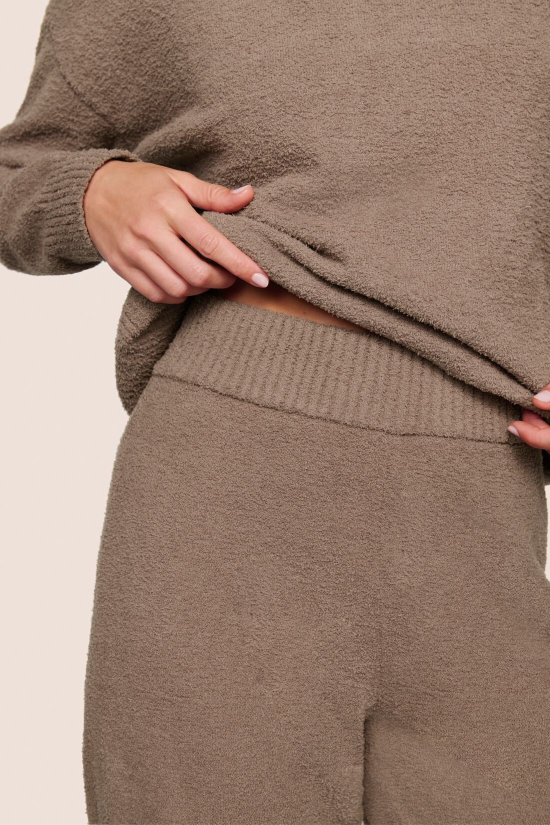 Model is wearing Recycled Boucle Pant  in Deep Taupe