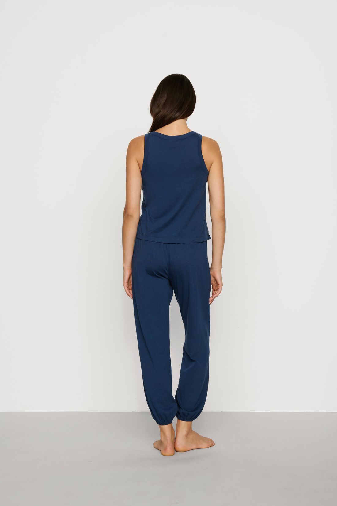 Model is wearing Aloe Cotton Pant in Navy