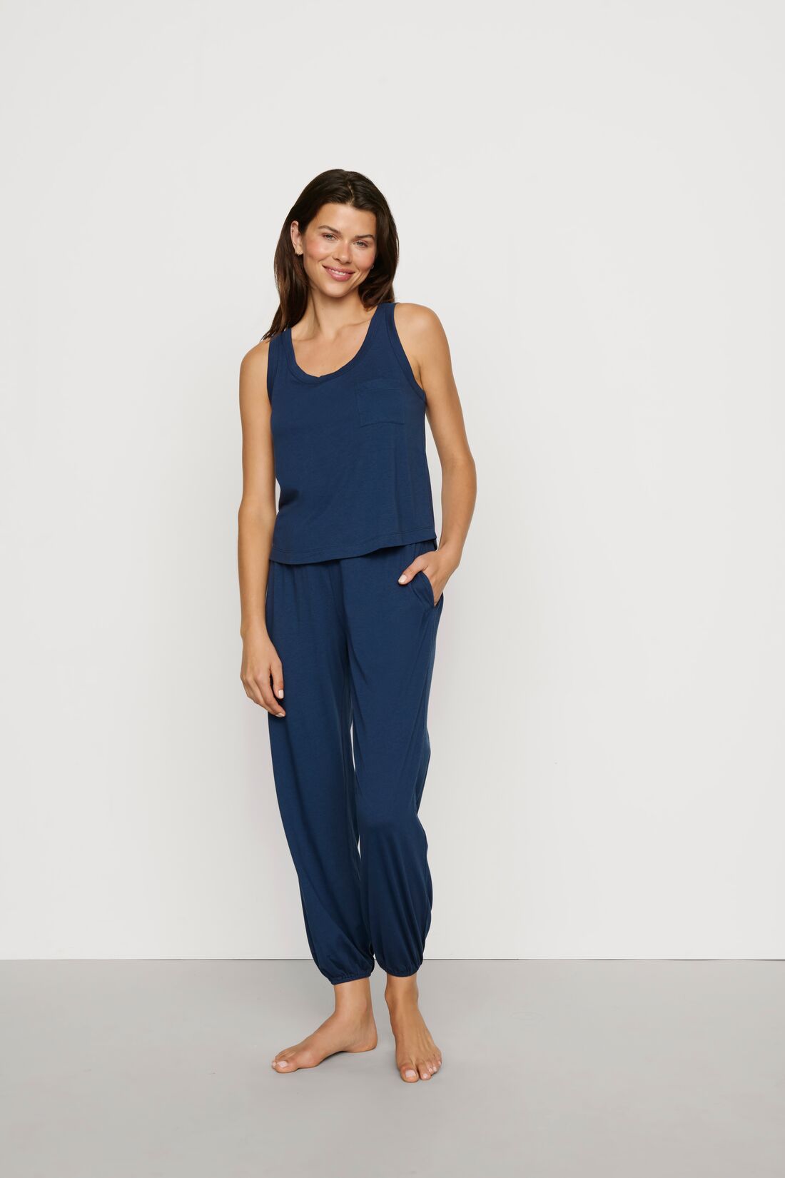 Model is wearing Aloe Cotton Pant in Navy