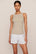 Model is wearing Essential Rib Tank in Beige