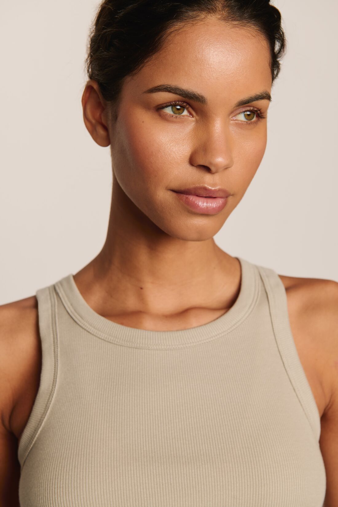 Model is wearing Essential Rib Tank in Beige