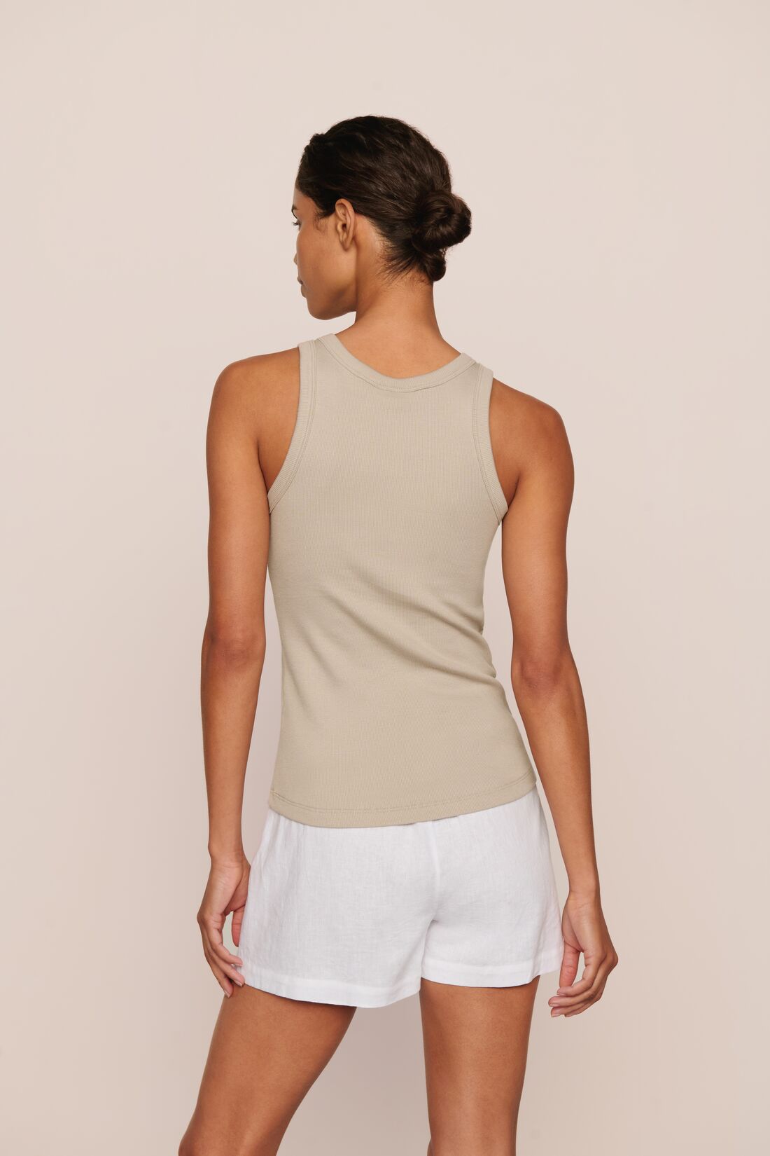 Model is wearing Essential Rib Tank in Beige