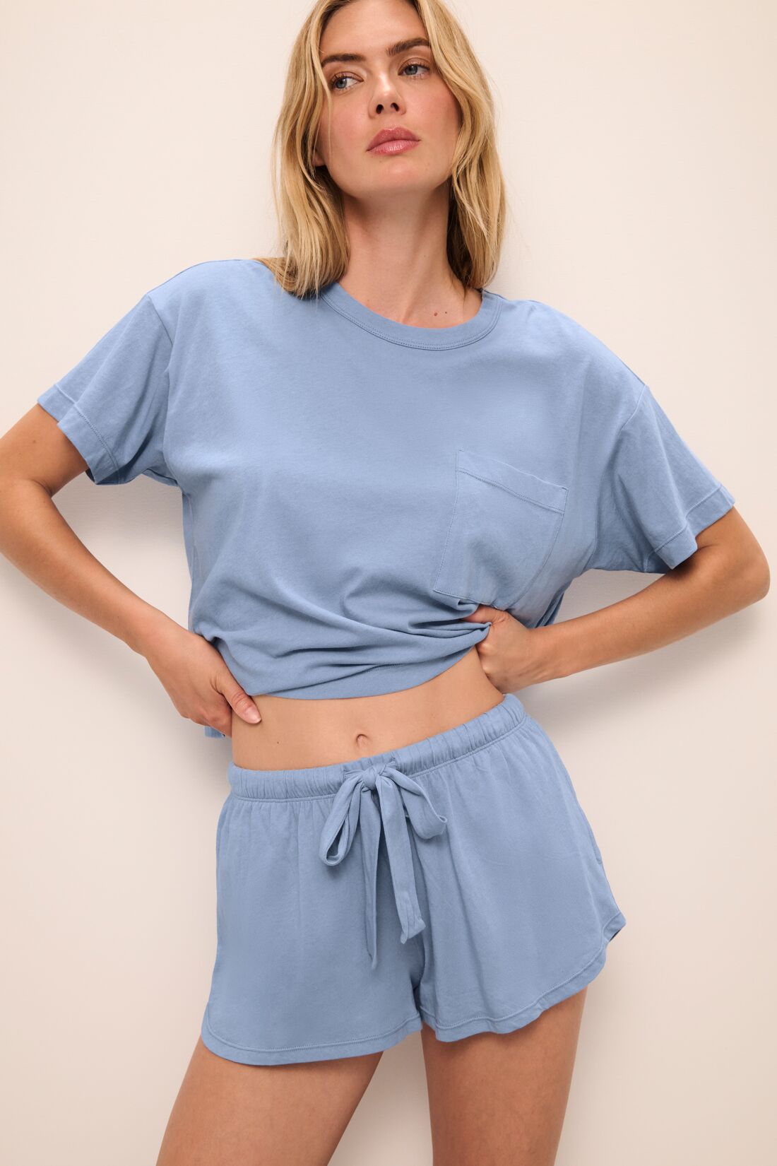 Model wears the Aloe Cotton Short Sleeve Tee in Wedgewood Blue.