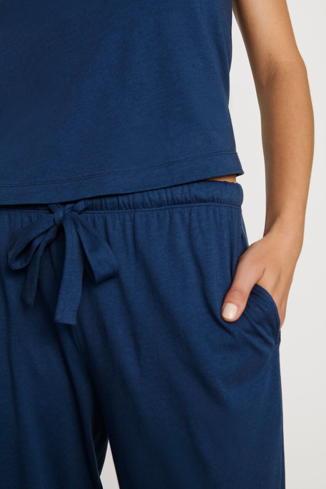 Model is wearing Aloe Cotton Pant in Navy