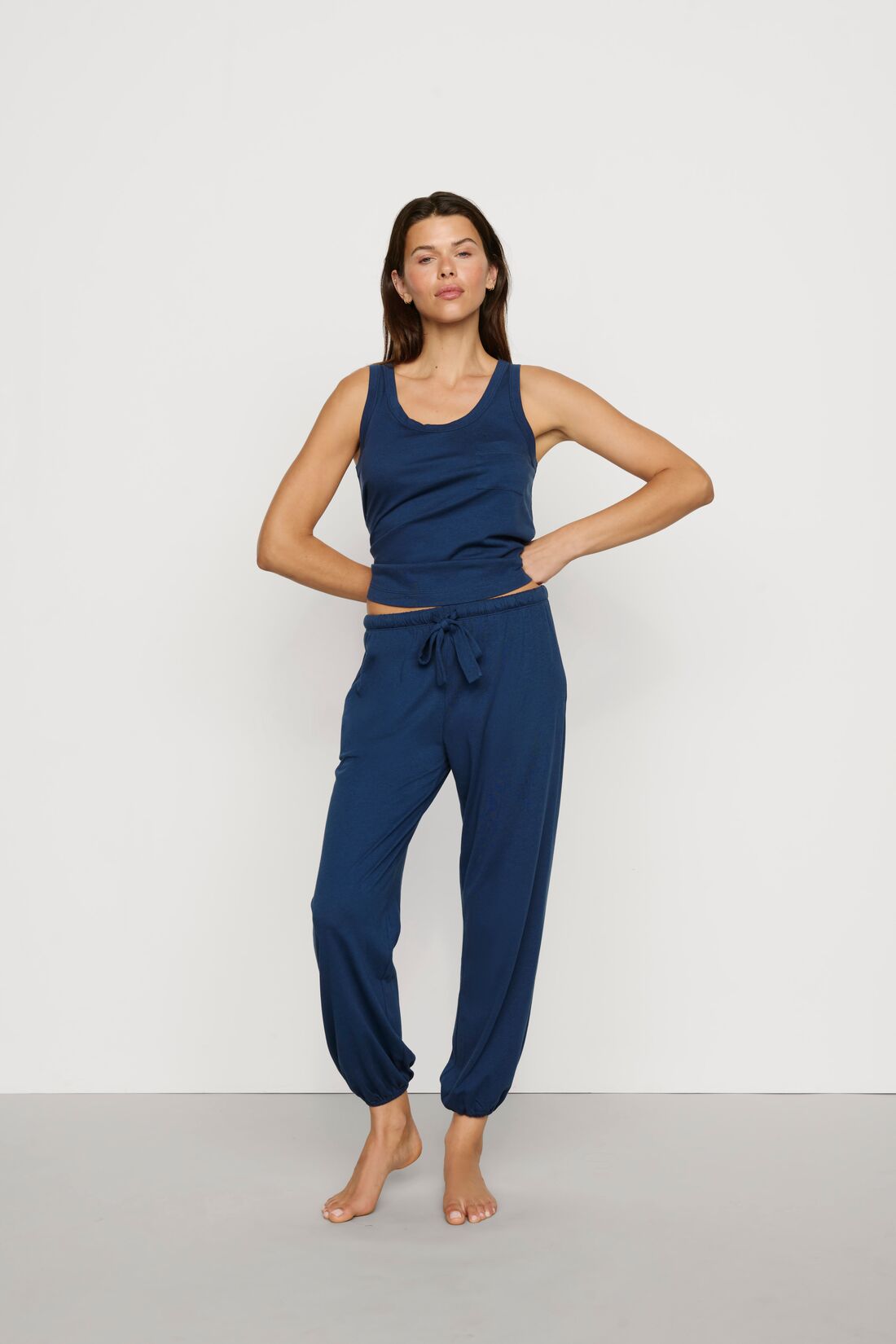 Model is wearing Aloe Cotton Pant in Navy