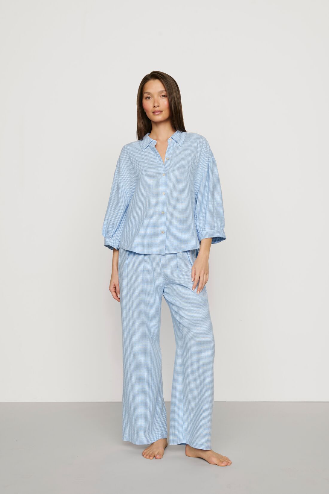 Model is wearing Linen Blend Relaxed Quarter Sleeve Top in Gingham White/Summer Blue