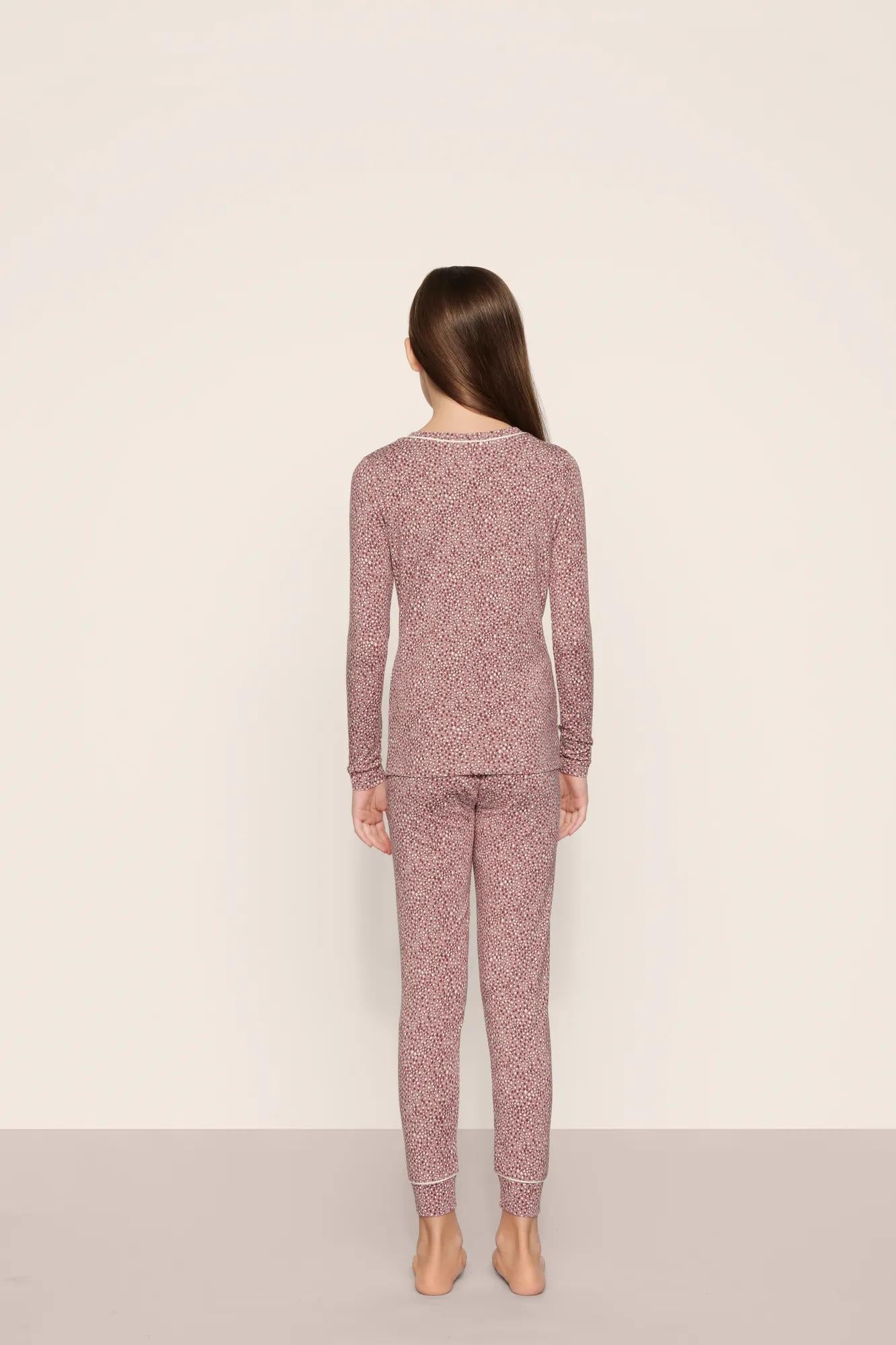 Model is wearing Kids Printed TENCEL™ Modal Unisex Long PJ Set in Animal Instinct Woodrose/Ivory