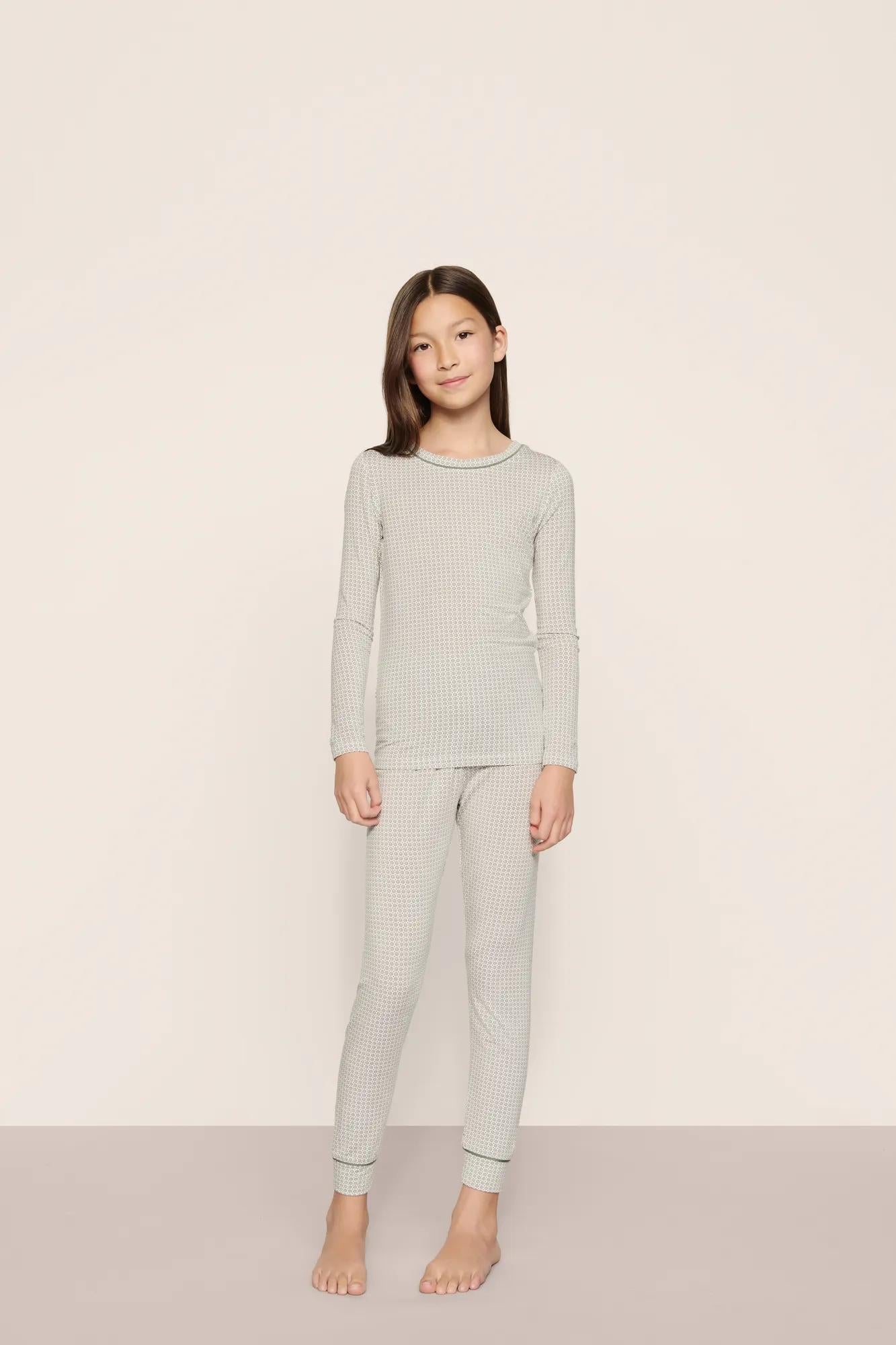 Model is wearing Kids Printed TENCEL™ Modal Unisex Long PJ Set  in  Geo Mod Desert Sage/Desert Sag