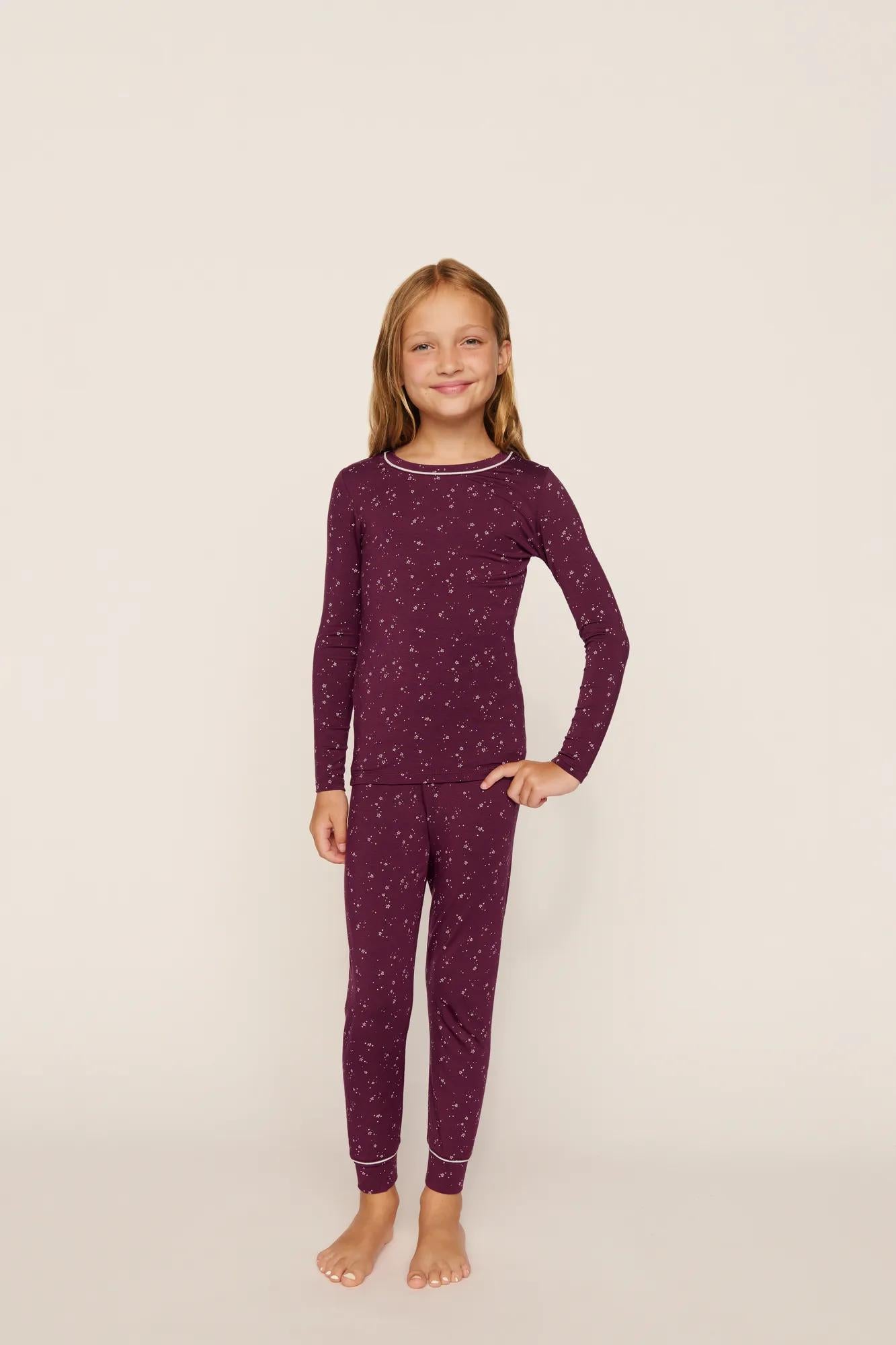 Model is wearing Kids Printed TENCEL™ Modal Unisex Long PJ Set in Starlight Wildberry/Ivory