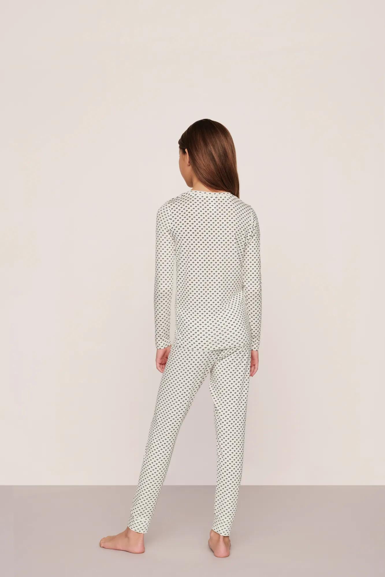 Model is wearing Kids Printed TENCEL™ Modal Unisex Long PJ Set in Tide Dot Ivory/Ivory