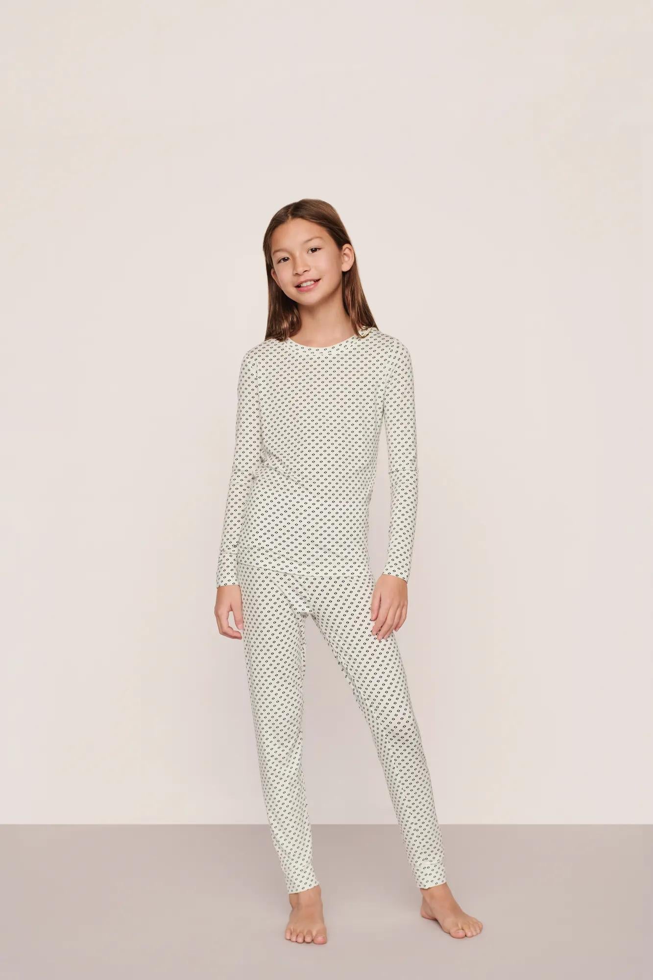 Model is wearing Kids Printed TENCEL™ Modal Unisex Long PJ Set in Tide Dot Ivory/Ivory