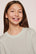 Model is wearing Kids Printed TENCEL™ Modal Unisex Long PJ Set in Tide Dot Ivory/Ivory