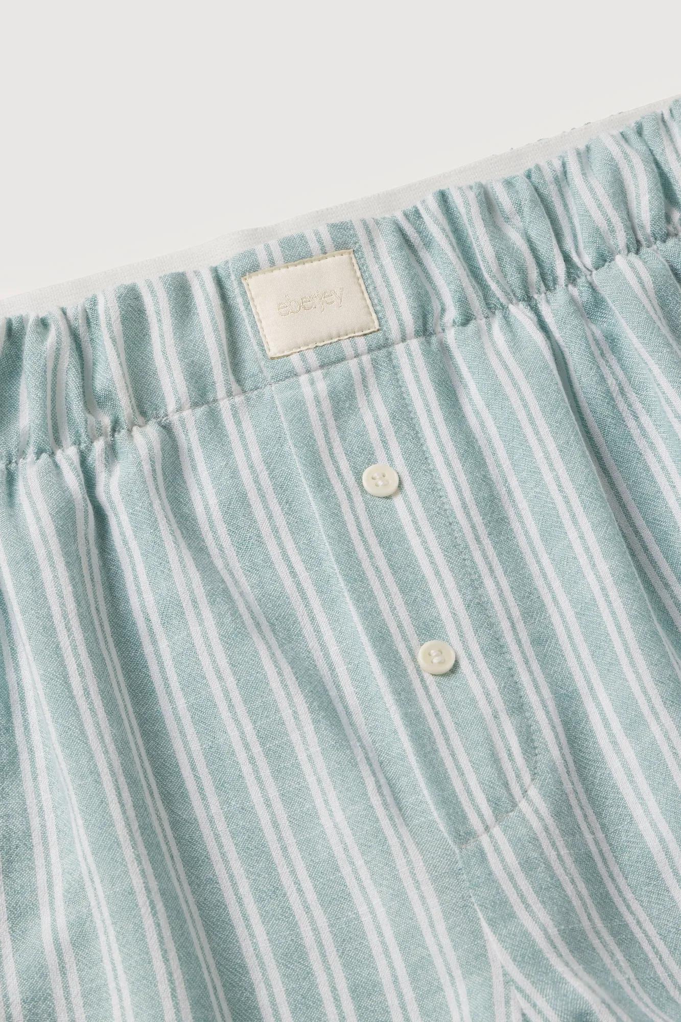 Model is wearing Nautico Boxer Pant in Regatta Stripe Seagrass/White