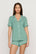 Model is wearing Gisele TENCEL™ Modal Relaxed Short PJ Set in Seagrass/White