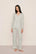 Model is wearing Gisele Printed TENCEL™ Modal Long PJ Set in Tide Dot Ivory/Ivory