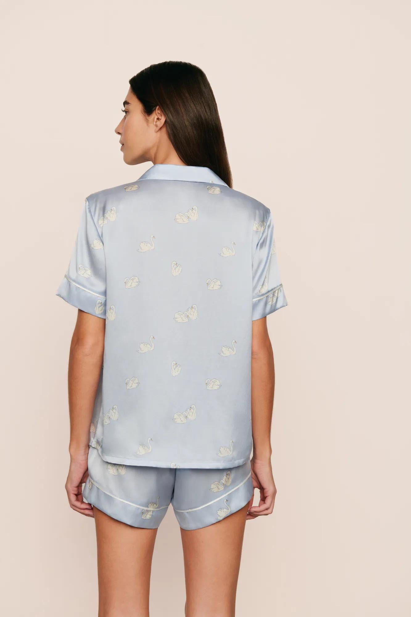 Model is wearing Inez Washable Silk Printed Short PJ Set in Large Swans Powder Blue/Ivory