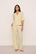 Model is wearing Nautico Relaxed Short Sleeve & Pant PJ Set in Classic Stripe Sunbeam/Ivory
