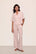 Model is wearing Nautico Relaxed Short Sleeve & Pant PJ Set in  Feeder Stripespale Mauve/White
