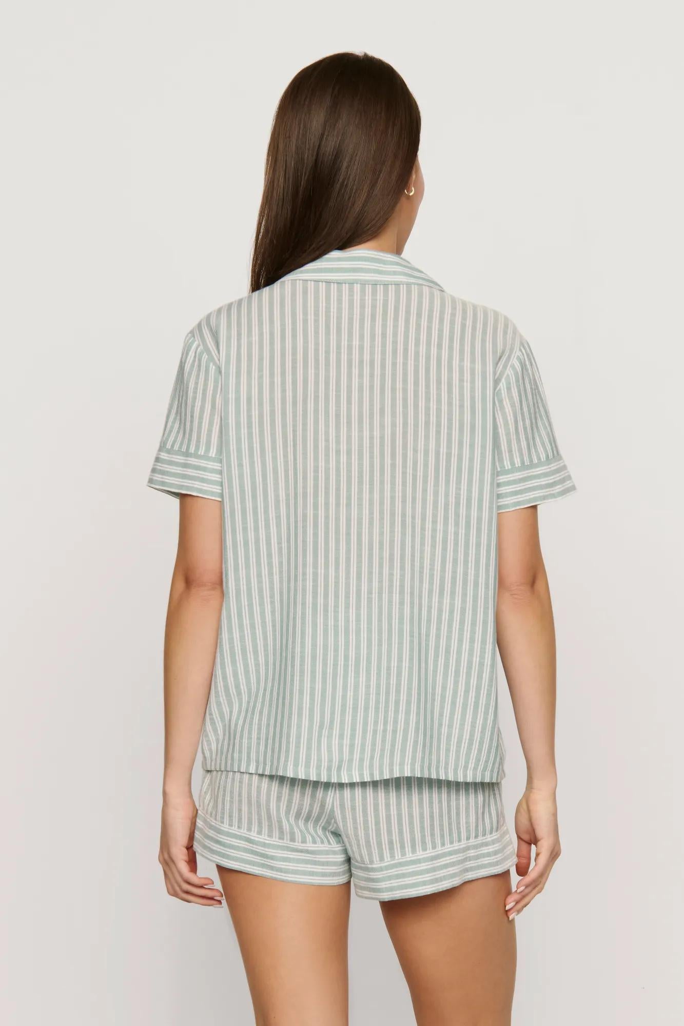 Model is wearing Nautico Shortie Short PJ Set in Regatta Stripe Seagrass/White