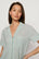 Model is wearing Nautico Shortie Short PJ Set in Regatta Stripe Seagrass/White