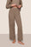 Model is wearing Recycled Boucle Pant  in Deep Taupe