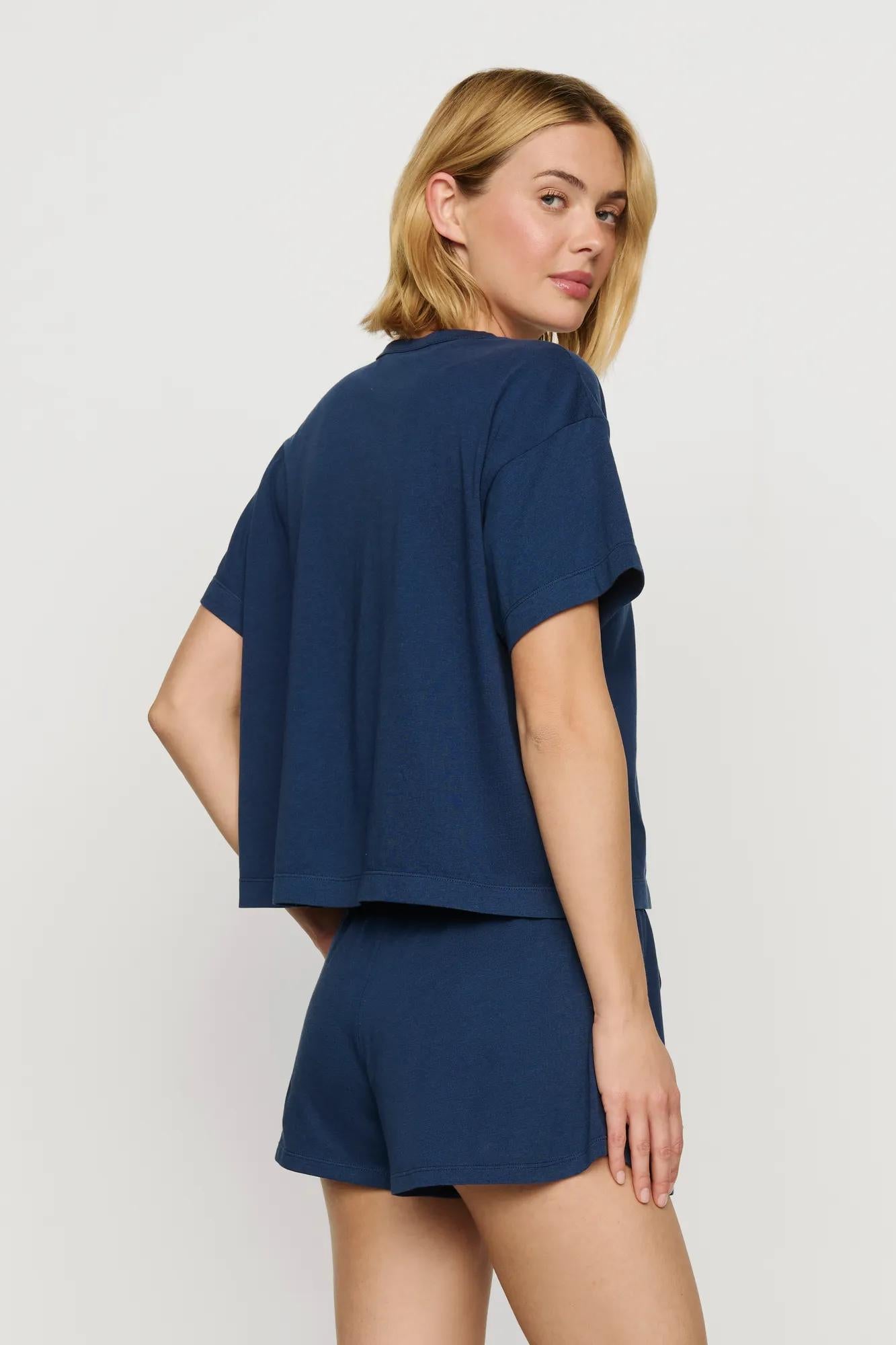 Model is wearing Aloe Cotton Short Sleeve Tee in Navy